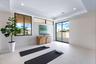 Interior space featuring large-format tile flooring, recessed ceiling lighting, clerestory windows, and glass sliding doors providing exterior exposur