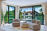 Floor-to-ceiling sliding glass walls, recessed ceiling lighting, and light-toned tile flooring