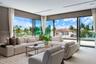 Floor-to-ceiling glass corner walls with multi-panel sliding doors, recessed linear lighting, and large-format tile flooring