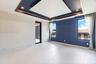 Tray ceiling with recessed lighting, large-format tile flooring, blue textured accent wall, and glass-paneled exterior door