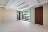Tray ceiling with recessed lighting, large-format tile flooring, textured wall covering, and sliding glass doors with external access