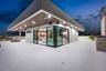 Expansive roof deck featuring large-format tile flooring, recessed overhead lighting, a covered exterior area with wood-finish ceiling, and sliding gl
