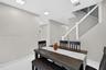 Interior space featuring large-format tile flooring, recessed ceiling lighting, and a staircase with a white handrail and horizontal metal cable raili