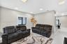 Neutral wall color, recessed ceiling lighting, and large-format tile flooring