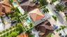 Aerial perspective featuring a tile roof, an in-ground swimming pool, and geometric paver hardscaping
