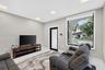Interior space featuring recessed lighting, smooth-finish walls, large-format tile flooring, a glass-panel door with a black frame, and a wide-format 