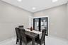 Interior space featuring large-format tile flooring, recessed ceiling lighting, and black-framed French doors with exterior access