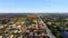Aerial perspective of a residential neighborhood featuring multiple ponds and expansive surrounding landscape