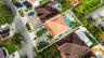 Aerial view of property featuring a hip roof, swimming pool, paver patio, and mature landscaping