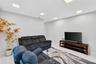 Neutral-toned interior space featuring light-colored tile flooring and recessed LED lighting
