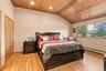 Vaulted wood-plank ceiling featuring recessed lighting, natural wood-finish flooring, and built-in closet with wood doors