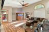 Vaulted ceilings, wood-finish flooring, arched transom window, built-in cabinetry, and recessed lighting