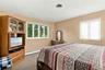 Neutral-toned interior room featuring wall-to-wall carpeting and two windows with white frames