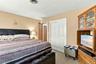 Neutral wall tones, carpeted flooring, and double-panel sliding closet doors with white trim