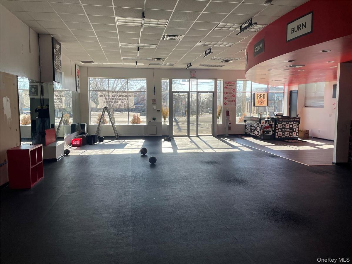 Workout area with a drop ceiling and a wealth of natural light