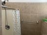 Bathroom featuring curtained shower