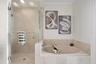 Primary ensuite bathroom with separate shower & garden soaking tub