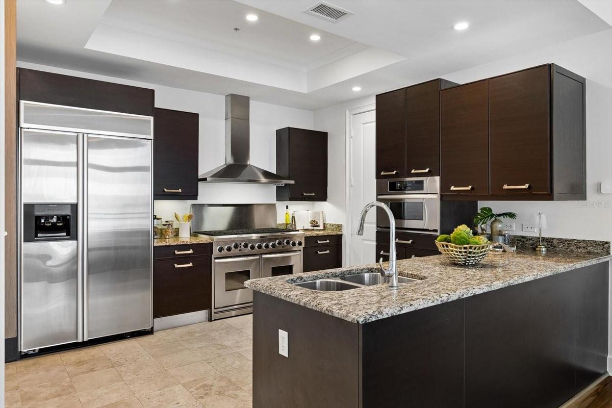 Kitchen with Kitchen aid appliances and gas range, pullout drawers for storage