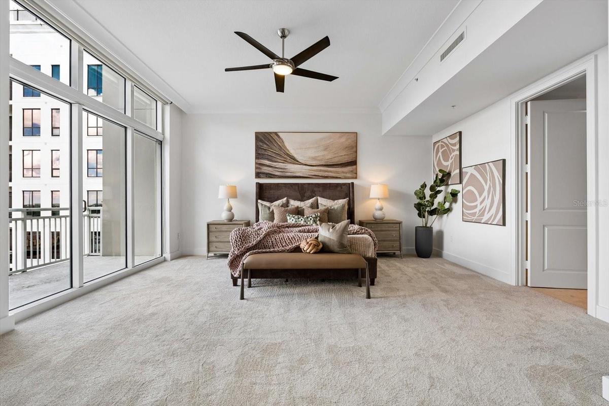 Oversized primary ensuite bedroom with private covered balcony
