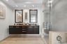 Primary bathroom with stone counters & dal sinks