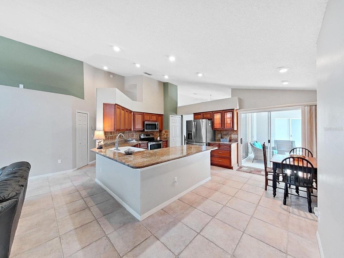updated kitchen with granite countertops, stainless appliances, recessed lighting