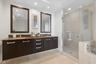 Primary bathroom with stone counters & dal sinks
