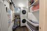 Inside laundry room with storage