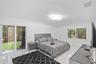 Polished stone-finish flooring, sliding glass door with exterior access, dual-pane window, and modern geometric flush-mount ceiling light fixture