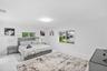 Expansive room featuring large-format white tile flooring, neutral walls, and dual sliding windows