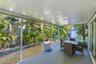 Screened-in porch featuring a painted concrete floor, a beadboard ceiling, and full-height mesh screening