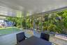 Screened-in patio featuring a concrete floor, white tongue-and-groove ceiling, and a full-height screen enclosure