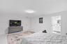 Interior space featuring large-format tile flooring, a flush-mount light fixture, and double-door closet storage