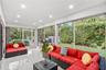Enclosed lanai featuring large-format stone-finish tile flooring, recessed ceiling lighting, and floor-to-ceiling screen paneling