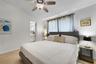 Neutral interior featuring tile flooring, a multi-blade ceiling fan with integrated lighting, and horizontal window treatments