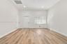 Neutral interior featuring wood-finish flooring, recessed lighting, and a multi-pane window with blinds
