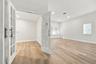 Wood-finish flooring, white French doors with glass panes, recessed lighting, and windows with horizontal blinds