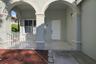 Covered entry porch featuring arched architectural detailing, stucco pillars, a white paneled front door, and a white metal balustrade
