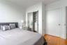Wood-finish flooring, sliding mirror closet doors, and built-in closet shelving featuring integrated drawers