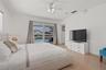 Kitchen featuring white cabinetry, stainless steel side-by-side refrigerator, built-in microwave, tile flooring, and recessed lighting