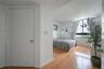 Wood-finish flooring and large window with exterior urban scenery