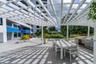 Expansive rooftop terrace featuring large-format tile flooring and a frameless glass perimeter railing