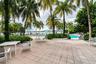 Fitness center featuring resilient rubberized flooring, recessed ceiling lighting, and large windows