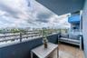 Covered balcony featuring tile flooring and horizontal metal railing