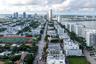 High-rise residential tower featuring multiple private balconies, a hard-surface tennis court, and immediate proximity to the waterfront