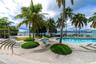 Fitness center featuring rubberized floor surfacing, full-wall mirrors, recessed lighting, and access to exterior space