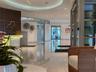 Mail room featuring integrated banks of metal parcel lockers, a central island with a solid surface countertop, wood-toned paneled walls with grid det