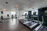 Fitness center featuring wood-finish flooring, full-length wall mirrors with wood frames, and glass-paneled double doors