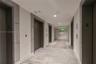 Lobby featuring polished stone flooring, recessed ceiling lighting, a curved architectural wall, and a built-in reception desk with illuminated stone-