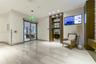 Lobby interior featuring full-height glass windows, backlit stone-clad pillars, polished stone flooring, and recessed ceiling lighting