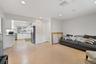 Open-concept living space featuring large-format ceramic tile flooring, expansive floor-to-ceiling windows, and recessed lighting